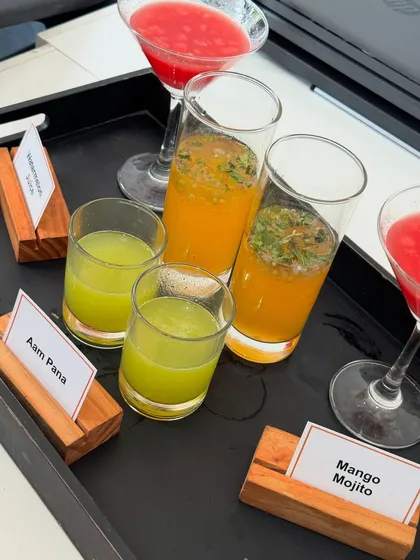 Our summer drink selection, featuring tangy Aam Pana and a refreshing Mango Mojito. We use fresh ingredients to create drinks that are both delicious and visually appealing.
