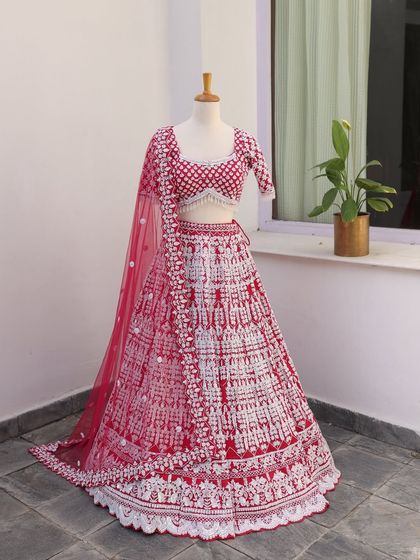 This red and white threadwork lehenga is a modern masterpiece. It's perfect for the bride who wants a unique, contemporary take on the traditional red outfit.