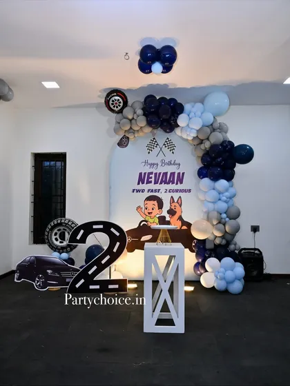 A full view of the car-themed birthday decor, showing the backdrop, balloon arch, and themed props arranged for a fun photo opportunity.