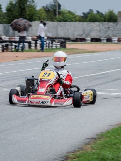 A victory pose from Mihir Avalakki as he takes the checkered flag, capping an unchallenged weekend of racing.