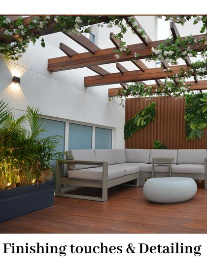 The final details make all the difference. This terrace features a beautiful wooden pergola with flowering vines, a comfortable L-shaped sofa, and integrated planters with up-lighting, creating a polished and inviting outdoor living room.