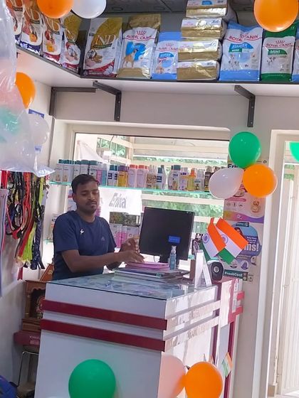 Me at the counter, ready to welcome you and your pet. The shop is decorated for a celebration, because every day with pets is a happy day.