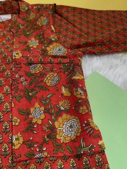 Earthy tones and intricate prints define this handcrafted cotton kurta set. The block-printed floral motifs in warm rust and mustard add a touch of timeless charm.