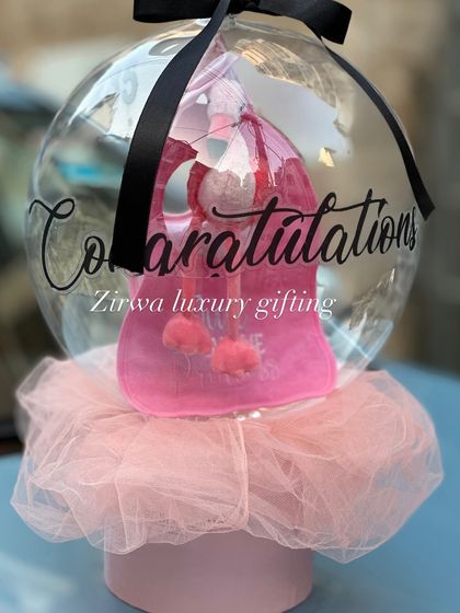A unique way to say congratulations on the new arrival. This gift features a cute pink baby bag presented inside my signature balloon packaging, making for a truly memorable and exciting reveal.
