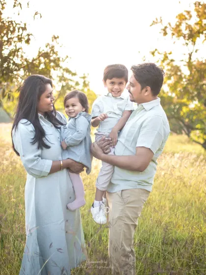Taking the session outdoors allows for a different kind of magic. Here, bathed in the golden hour light, a family of four shares a moment of connection, creating a timeless lifestyle portrait.