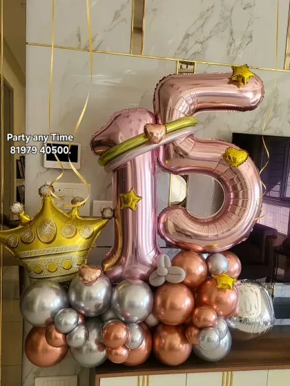 A 15th birthday balloon bouquet with a princess crown foil balloon and rose gold colors.
