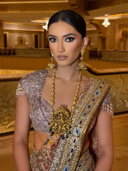A direct, powerful portrait. The makeup is all about the eyes, with a dark, smudged liner that exudes confidence.