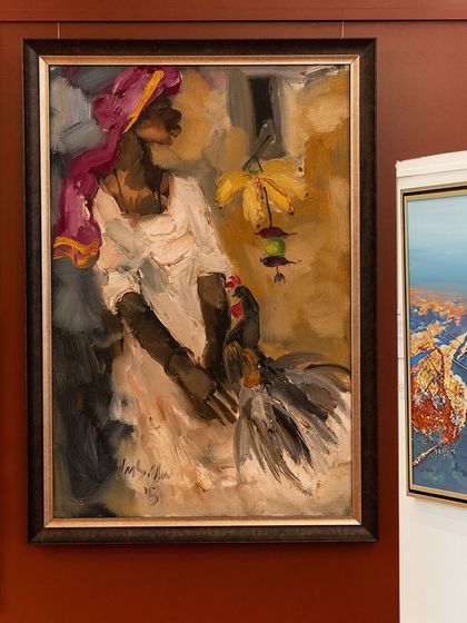 A visitor admires a powerful figurative painting, capturing a moment of quiet connection during our month-long exhibition celebrating South Indian artists.