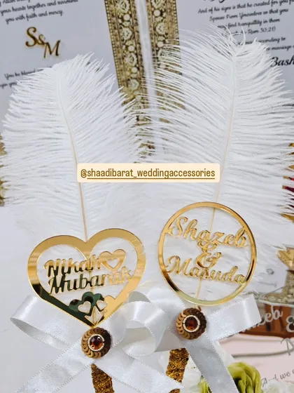 A close-up of my custom Nikah pen toppers. I can create them with acrylic cutouts of your names or phrases like "Nikah Mubarak" to make your signing pen unique.