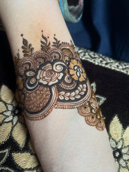 Another angle of the armband, showing the floral and paisley elements.