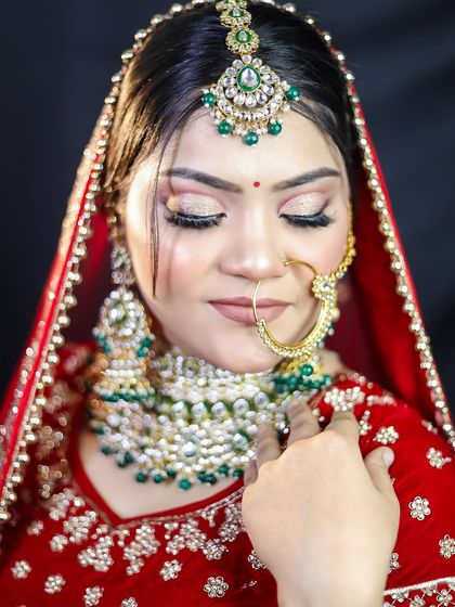 A classic red bridal look with a focus on the eyes, featuring a soft, shimmery eyeshadow and dramatic lashes.