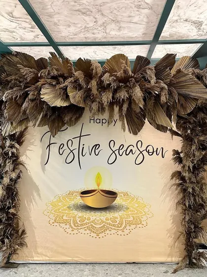 A festive backdrop we designed for a corporate client. We used a custom printed banner and framed it with an arch of dried pampas grass for a modern, earthy look.