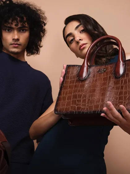 For luxury brand Eske Global, we created a series of clean, elegant studio shots. This image focuses on the product's premium feel, using two models to create a dynamic composition that highlights the texture and craftsmanship of the leather handbag.