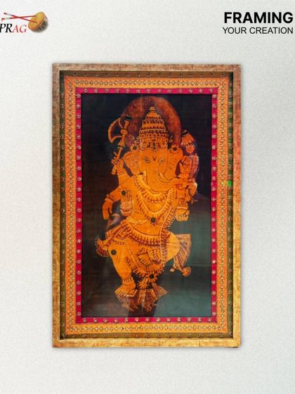 This framed Tanjore painting of Ganesha is a beautiful example of preserving sacred art. The ornate gold frame and rich inner mount echo the divinity and opulence of the artwork itself.
