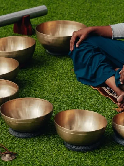 Sound healing bowls set up on the grass, a unique offering for corporate wellness retreats designed to promote relaxation and mindfulness.