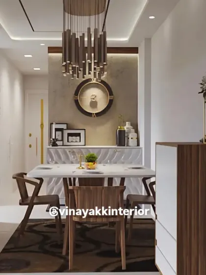 This modern dining area is designed for elegant meals and conversations. A statement chandelier hangs over a sleek marble-top table, surrounded by contemporary wooden chairs. The design balances luxury with a clean, open layout.