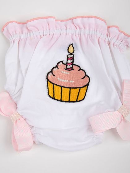 A close-up of the cupcake-themed diaper cover with pink bows.