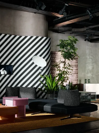 Another angle of the striped lounge area, showing how the space is balanced with plants and other textured elements like the woven screen.