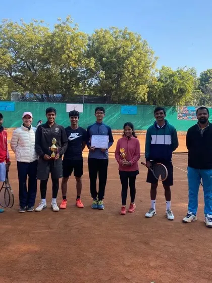 A group photo of my players and coaches on the clay court after a successful week at the CS7 tournament.