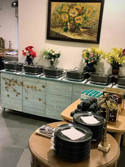 A compact buffet setup inside a home, showing how I can work with existing furniture to create an elegant food display. Perfect for house parties from 20 to over 300 guests.