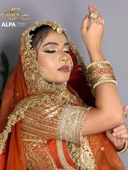 A graceful pose that brings attention to the traditional jewelry and the complementary makeup.