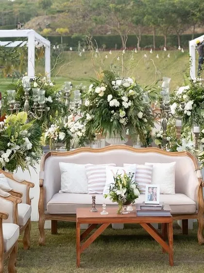 A sophisticated lounge area at the 'Luxe Garden' wedding, with classic furniture and personalized cushions.
