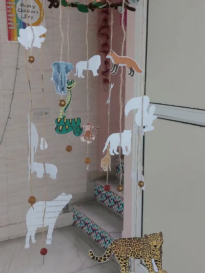 A closer look at our handmade animal mobile, crafted with natural twigs and paper cutouts.