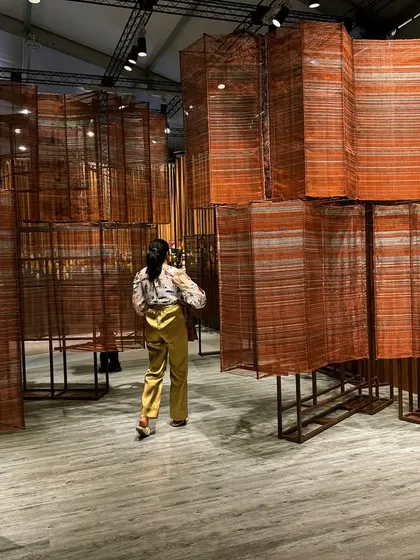 This walkthrough installation explores the dialogue between tradition and industry. We meticulously hand-wove copper wires on a loom in our studio, creating a flowing, multi-dimensional sculpture. The metallic surface acts like a gleaming river, reflecting India's rich history while embracing a contemporary aesthetic.