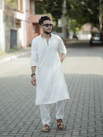 The groom deserves his moment too. This portrait showcases a modern, stylish groom, capturing his personality with a relaxed and confident pose before the wedding festivities begin.