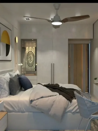 This view shows the other side of the bedroom, with a compact study desk and TV unit, demonstrating efficient space planning.