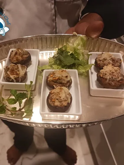 A platter of baked stuffed mushrooms, a classic vegetarian starter.