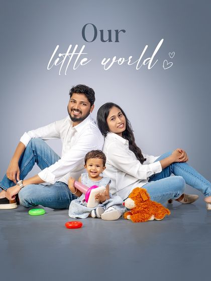 This is our little world. The simple, coordinated look of white shirts and jeans creates a clean, timeless family portrait that feels both classic and modern.