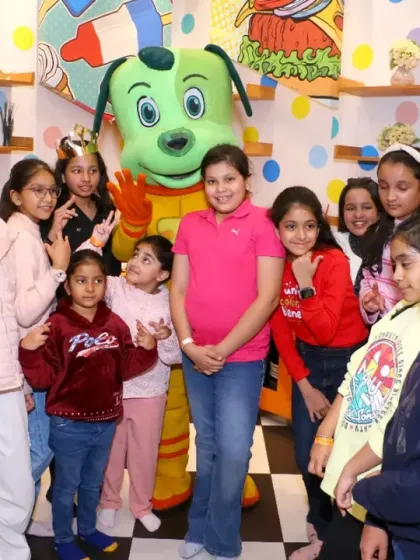 A large group of friends gathers around Tinga Dojo for a picture, celebrating a birthday or group playdate.