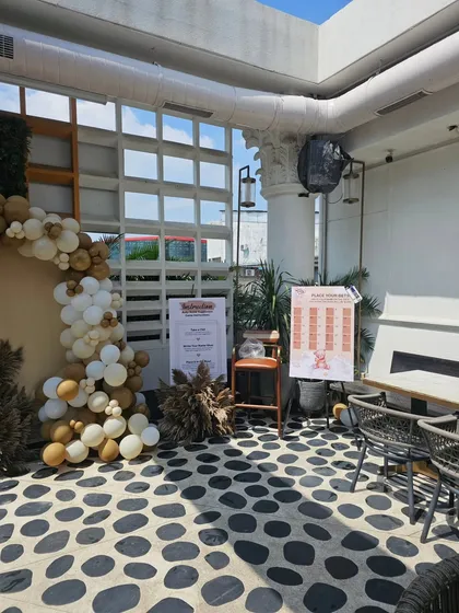 Another angle of the rustic baby shower, showing the welcome sign and game boards placed for guests.