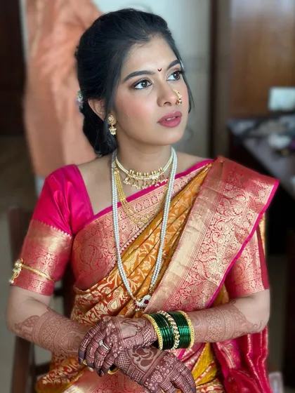 A thoughtful pose capturing the bride's serene beauty. The makeup is kept minimal and elegant, with a focus on enhancing her natural features.