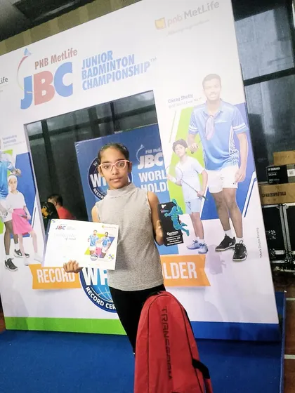 Akshita proudly displays her trophy and certificate after a strong performance at the PNB Metlife JBC Badminton Championships, where she also defeated the top-seeded player.