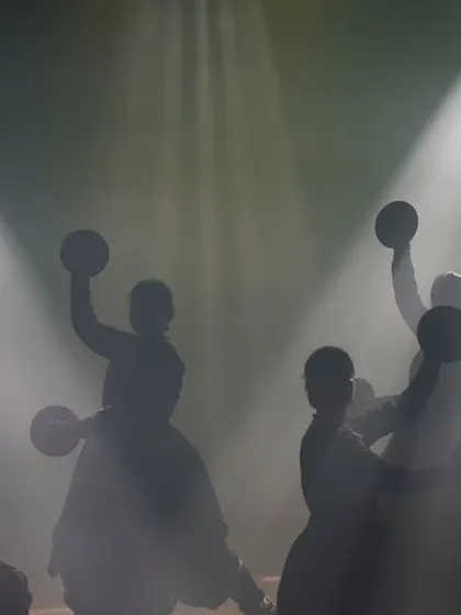 A silhouette of our dancers during a performance. I often use lighting to create powerful visual effects, highlighting the form and unity of the ensemble.