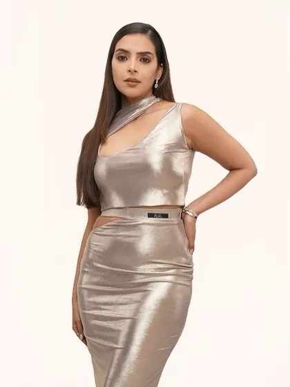 This shot showcases the clean lines of the outfit and the complementary soft glam makeup. The radiant base and subtle pop of highlight enhance the model's features.