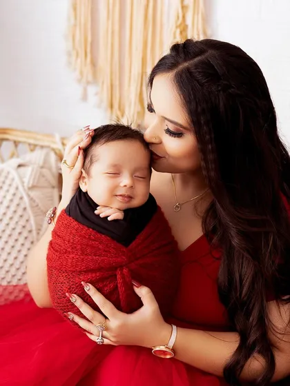 A mother's gentle kiss for her smiling newborn. These are the simple, heartfelt moments I aim to freeze in time for you.