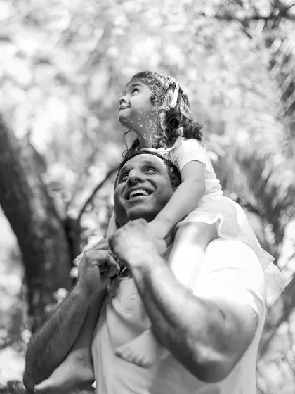 The love a father has for his daughter is so powerful. This black and white image, looking up through the trees, captures a moment of pure joy and wonder.