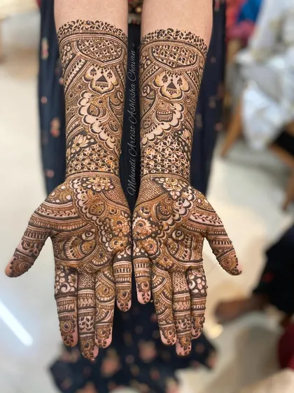 A beautiful example of a full-coverage Indian mehendi design. The patterns are dense and intricate, featuring a mix of floral and geometric motifs.