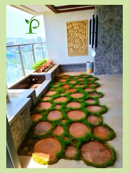 Who says you need a backyard for a lawn? I designed this unique balcony floor with wooden log slices set in a bed of soft, green artificial grass, bringing the feeling of a natural pathway to this urban apartment.