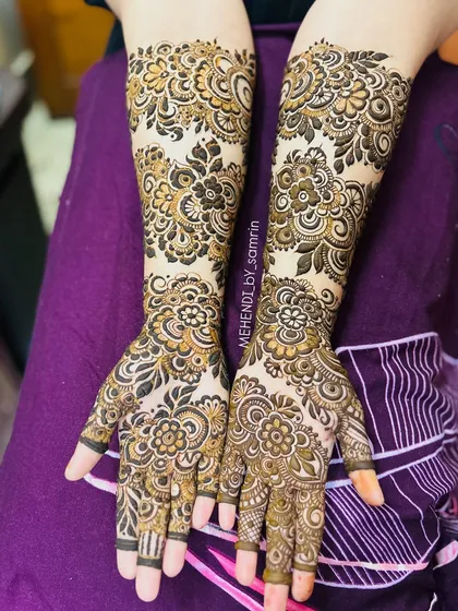 A full and festive design for a beautiful client's 'baat pakki' ceremony. This style combines dense floral work with traditional patterns, covering both hands and extending up the arms for a stunning celebratory look.