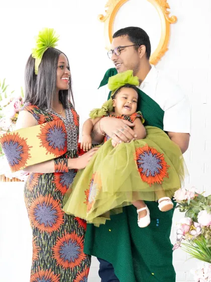 A vibrant family portrait filled with laughter and joy. The family wears unique, coordinated outfits, and their candid interaction shows off their fun-loving personalities.