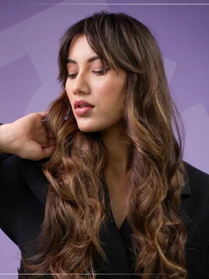 A closer look at the soft, flowing waves that showcase the beautiful blend of brunette and honey-toned highlights. This style is versatile and looks stunning whether worn straight or curled.