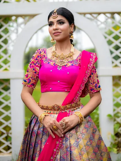 For ethnic wear brands, I focus on capturing the richness of the fabric and the intricacy of the design. This full-length shot of a Kanjeevaram half saree uses bright, natural lighting to make the vibrant pink blouse and detailed embroidery pop, perfect for a designer lookbook.