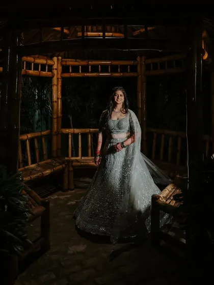 A stunning wide shot of the engagement bride in a beautiful gazebo. The makeup stands out even from a distance, highlighting her features perfectly.