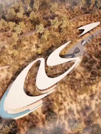 The calligraphic roofline of Amar Villa is visible in this aerial view, showcasing the fluidity of the design as it moves through the landscape.