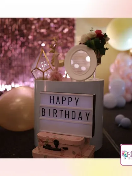 A close-up of the charming details from Aarna's Disney Princess themed birthday party. We used a "Happy Birthday" lightbox, a vintage-style suitcase, and a lovely floral arrangement to create a whimsical and personal touch for the celebration.