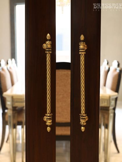 This image captures the intricate, twisted design of the Chelsea pulls, highlighting the craftsmanship and the warm glow of the Antique Gold finish.